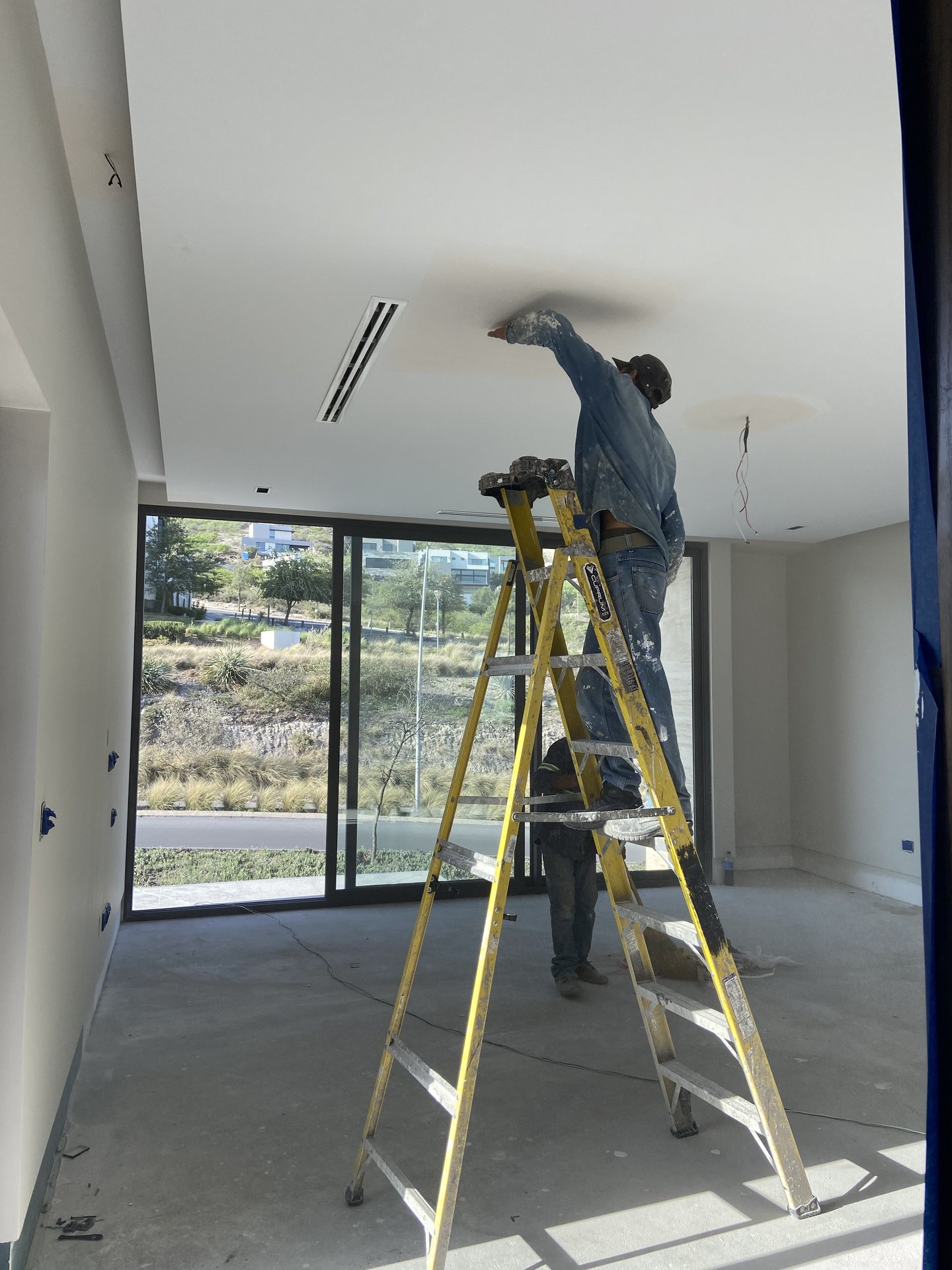 Técnico Cachay inspeccionando plafón y sistema de clima con equipo profesional